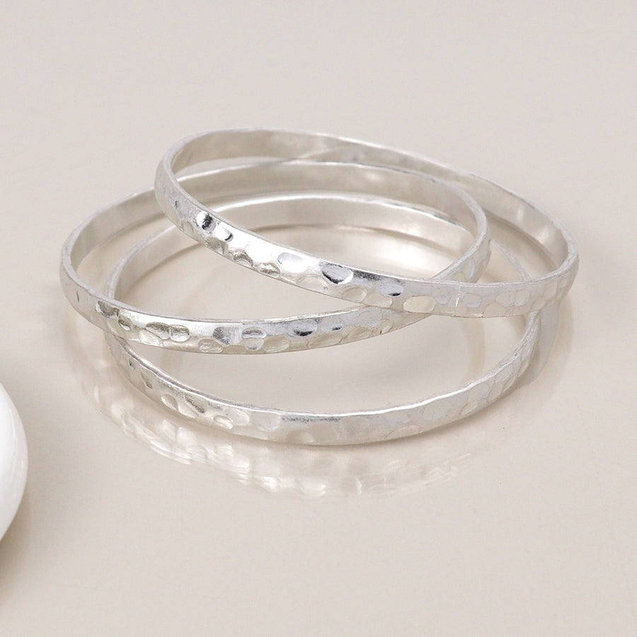 Silver plated worn triple bangle set
