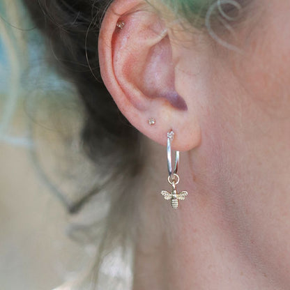 Silver plated hoop earrings with golden bee charm