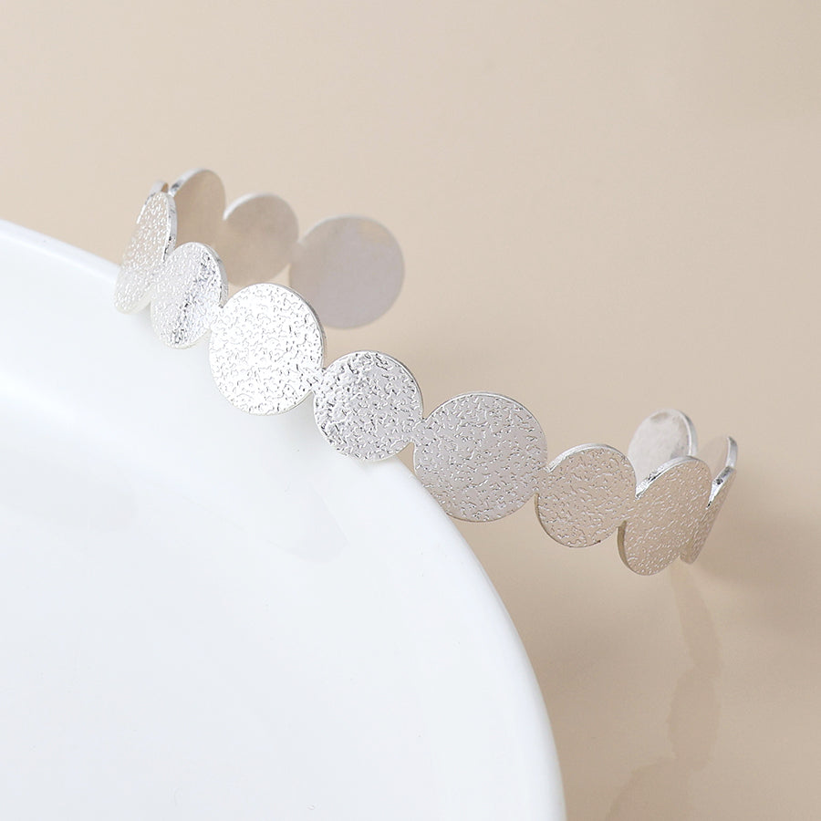 Silver plated dappled disc bangle