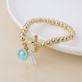 Golden t-bar bracelet with shell and pearl charms
