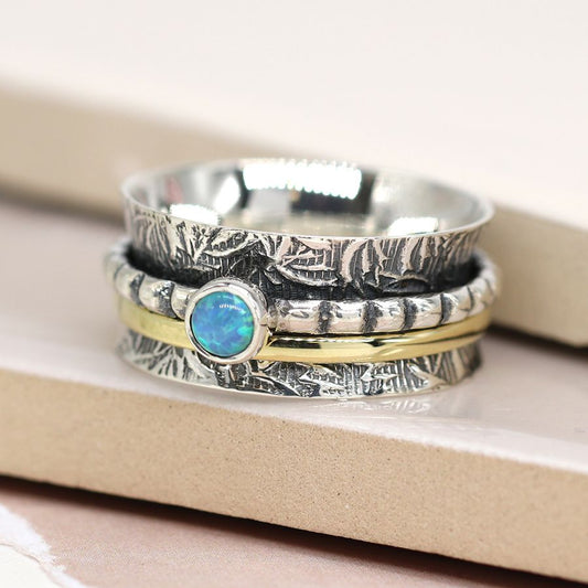 Sterling silver embossed spinning ring with opal