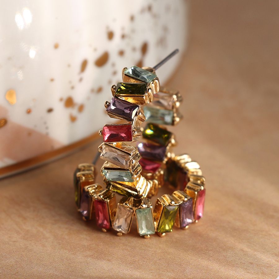 Golden staggered multicoloured crystal hoop earrings